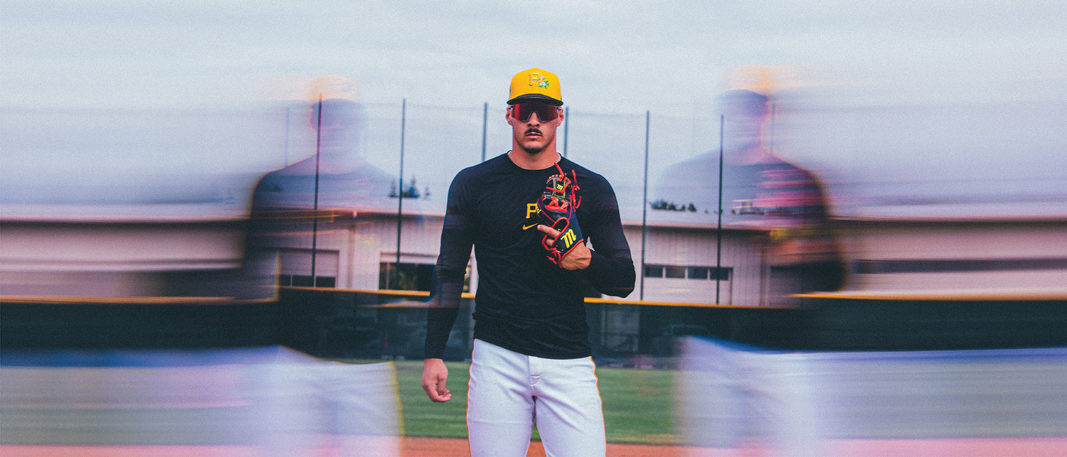 Konnor Griffin of the Pittsburgh Pirates with a pair of 100Percent x MLB Authentics Speedcrafts on a baseball field with a blurred background.