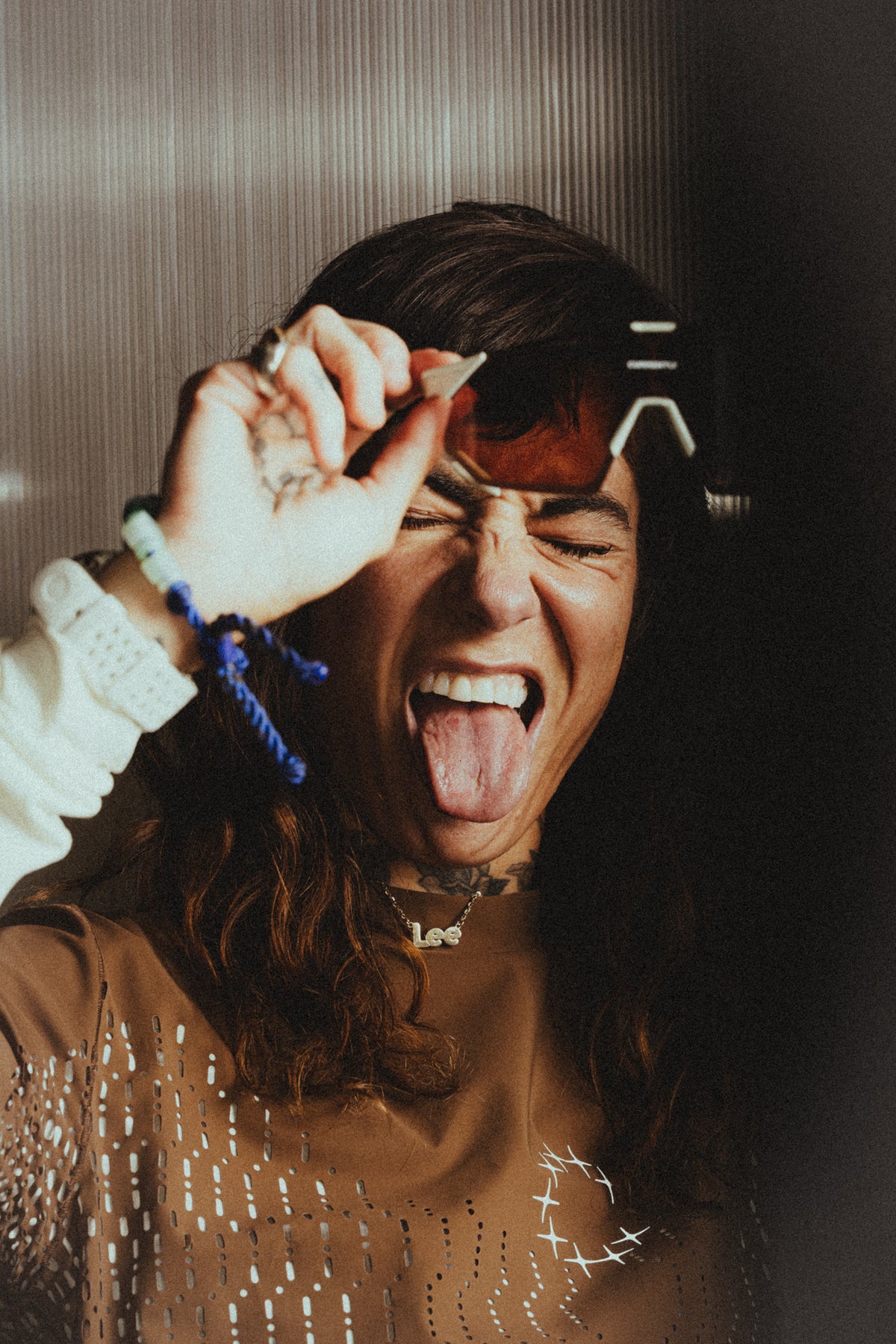 Currently Running™ x 100Percent® Collection - Featuring a girl runner wearing a Currently Running top and 100Percent Hypercraft® SQ Sunglasses on a dark-warm moody background.