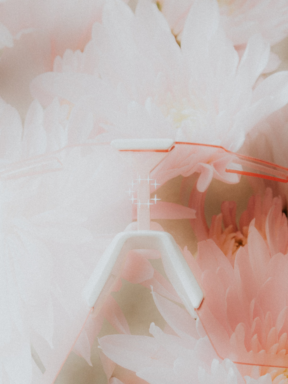 A close-up of a Currently Running™ x 100Percent® Collection Hypercraft® SQ with  soft pink and white flowers.