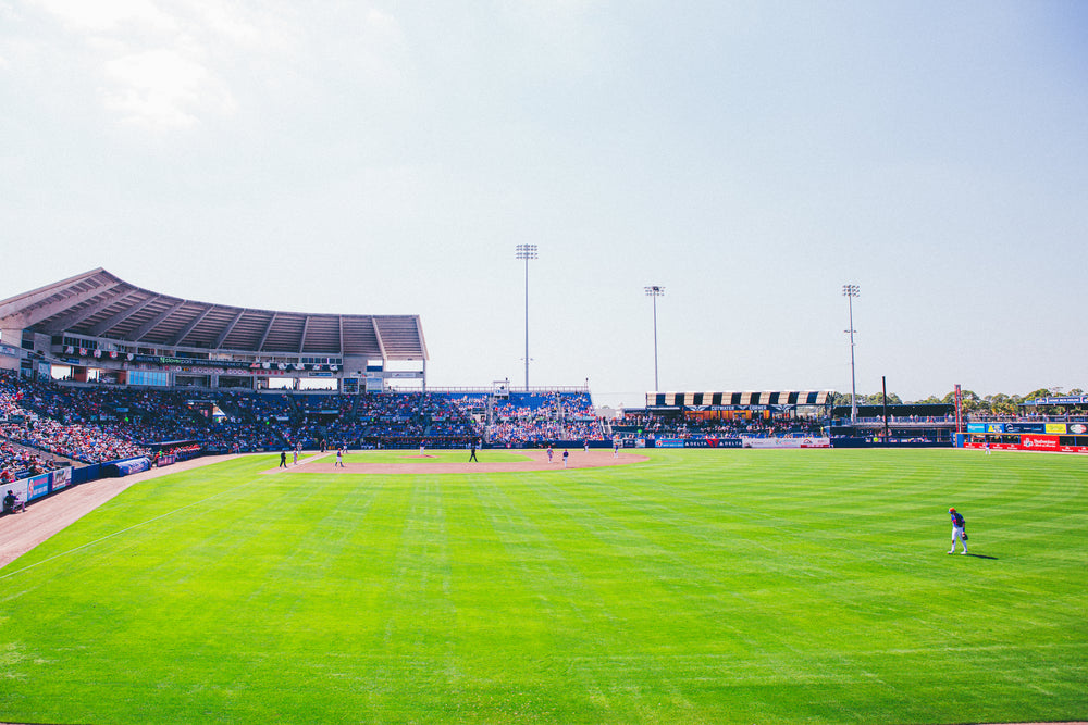 Baseball stadium with a clear sky and green field