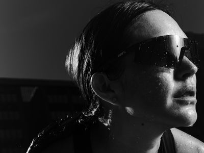 100Percent® A2 Running Sunglasses on a Woman on a Black/White Background
