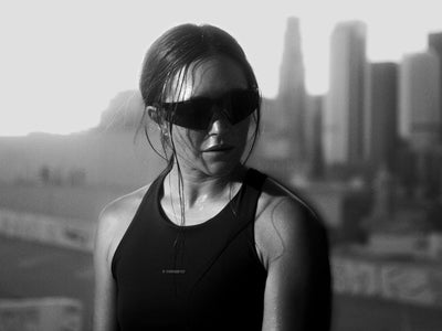 100Percent® A2 Running Sunglasses on a woman on a black/white city background